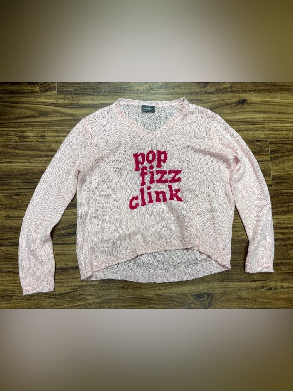 Wooden Ships V-neck knit sweater, light pink with red "pop fizz clink" graphic a